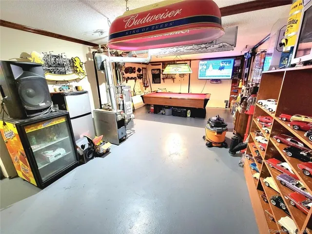 a garage with furniture and a flat screen tv