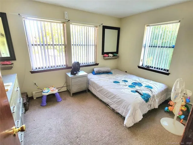 a bedroom with bed and a window