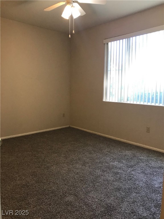 5155 West Tropicana Avenue, Unit 1155 Las Vegas, NV 89103 - Photo 10 of 11 Empty room featuring dark carpet and ceiling fan