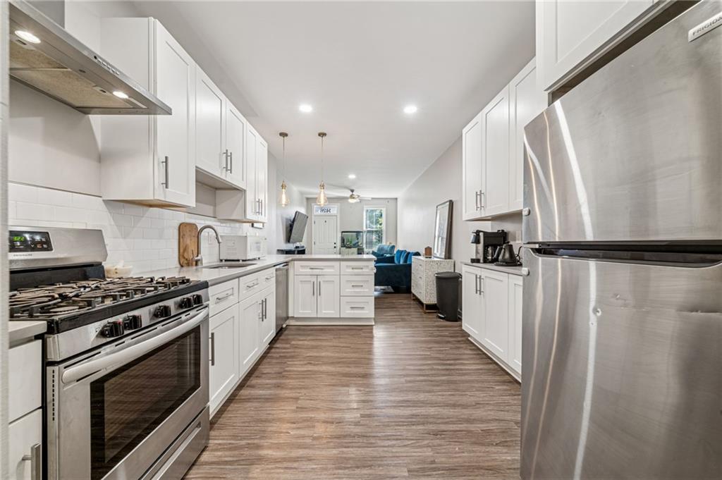 1426 Rush Street Pittsburgh, PA 15233 - Photo 16 of 30 a kitchen with stainless steel appliances a refrigerator sink and wooden floor