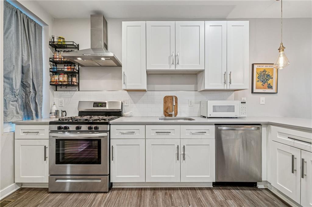 1426 Rush Street Pittsburgh, PA 15233 - Photo 17 of 30 a kitchen with stainless steel appliances granite countertop a stove and white cabinets