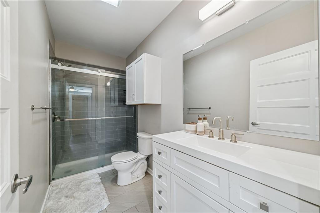 1426 Rush Street Pittsburgh, PA 15233 - Photo 27 of 30 a bathroom with a sink a toilet and shower