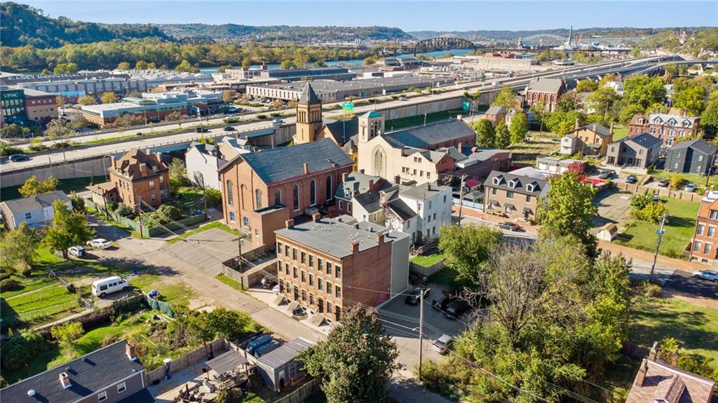 1426 Rush Street Pittsburgh, PA 15233 - Photo 5 of 30 an aerial view of a house with a yard and lake view