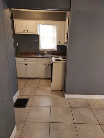 a kitchen with a sink a stove and a microwave