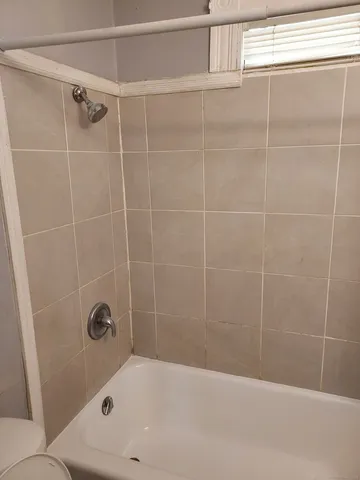 a bathroom with a bathtub and shower
