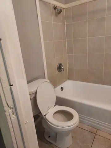 a bathroom with a toilet and a bathtub