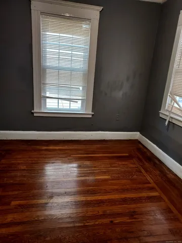 a view of room with window and wooden floor