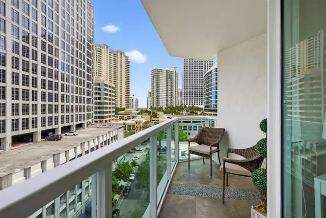 a view of balcony with a potted plant and outdoor seating