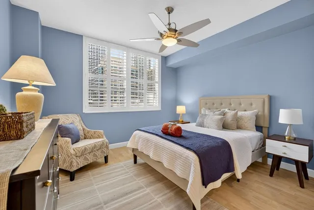 a bedroom with a bed and wooden floor