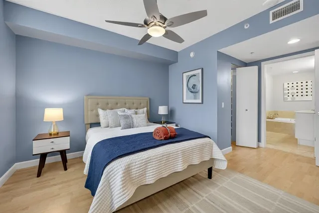 a bedroom with bed and a chandelier