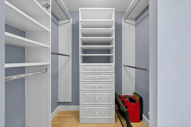 a view of walk in closet with empty racks