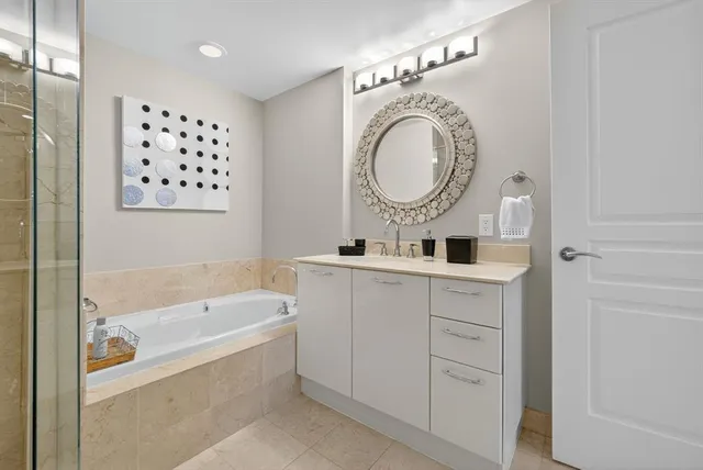 a bathroom with a bathtub a sink and a mirror