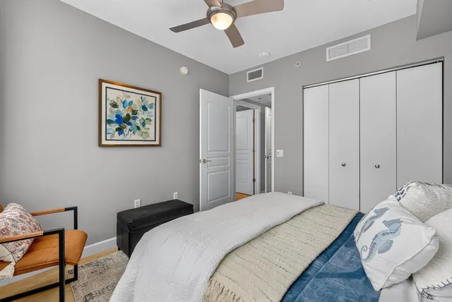 a bedroom with a bed and a chandelier