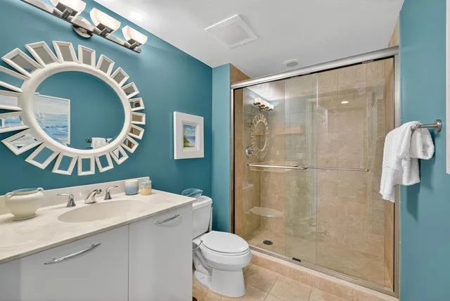 a bathroom with a toilet a sink and a mirror