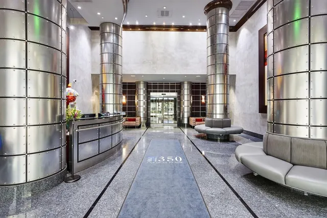 a lobby with a couch and chandelier