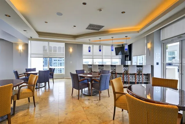 a dining room with stainless steel appliances kitchen island granite countertop a table and chairs