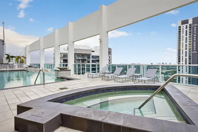 a view of a house with a backyard porch and sitting area