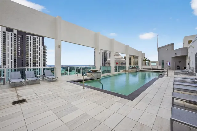 a view of a swimming pool and lounge chair