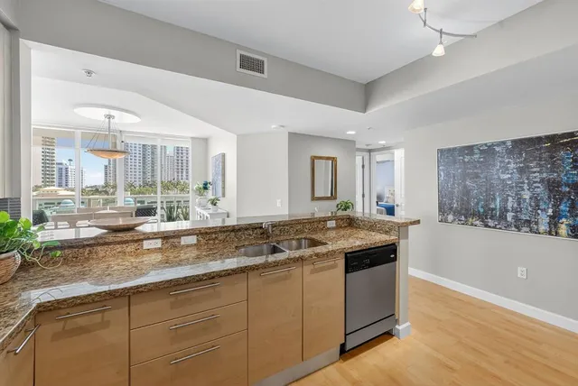 a kitchen with stainless steel appliances granite countertop a sink and cabinets