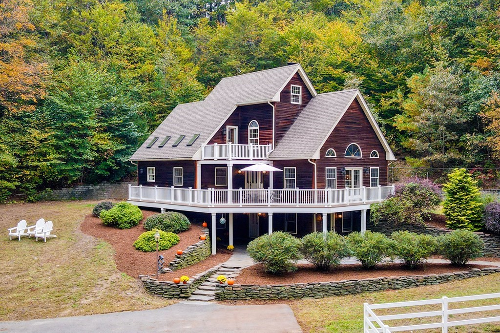 a front view of a house with a yard and potted plants