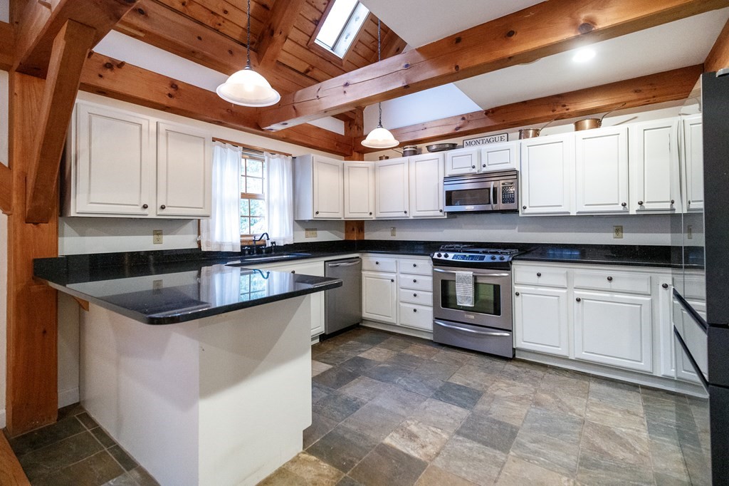 77 Swamp Road Montague, MA 01351 - Photo 12 of 35 a kitchen with stainless steel appliances granite countertop a sink a stove and cabinets