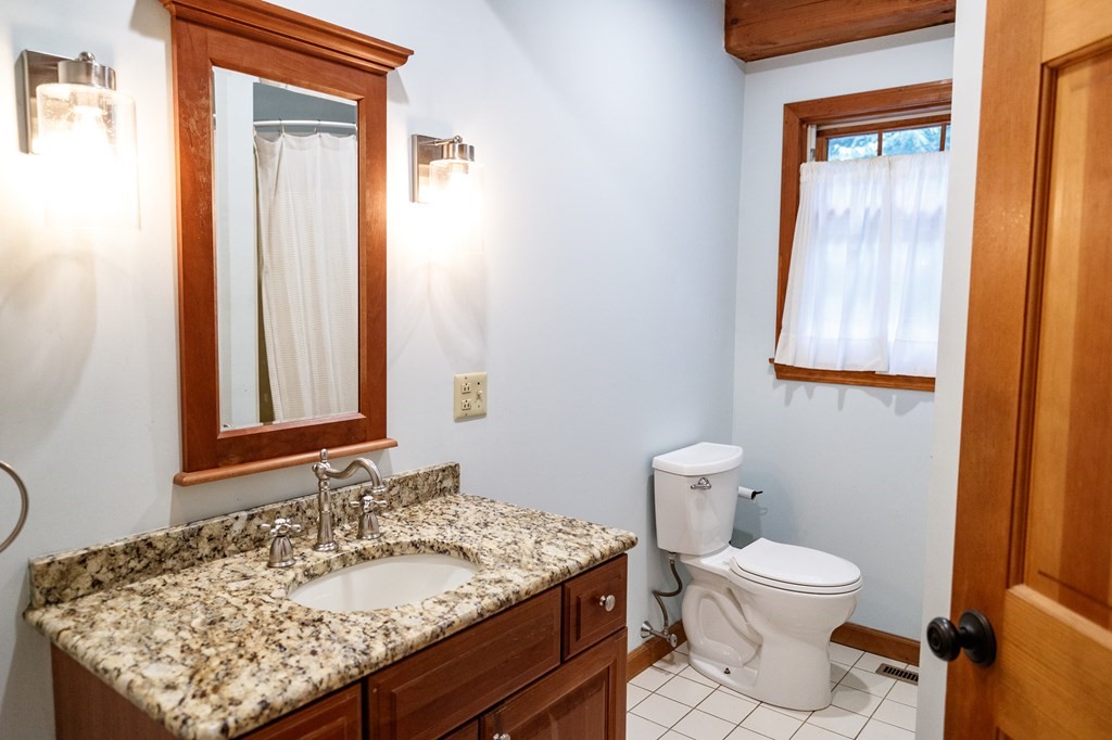 77 Swamp Road Montague, MA 01351 - Photo 19 of 35 a bathroom with a sink a toilet and mirror