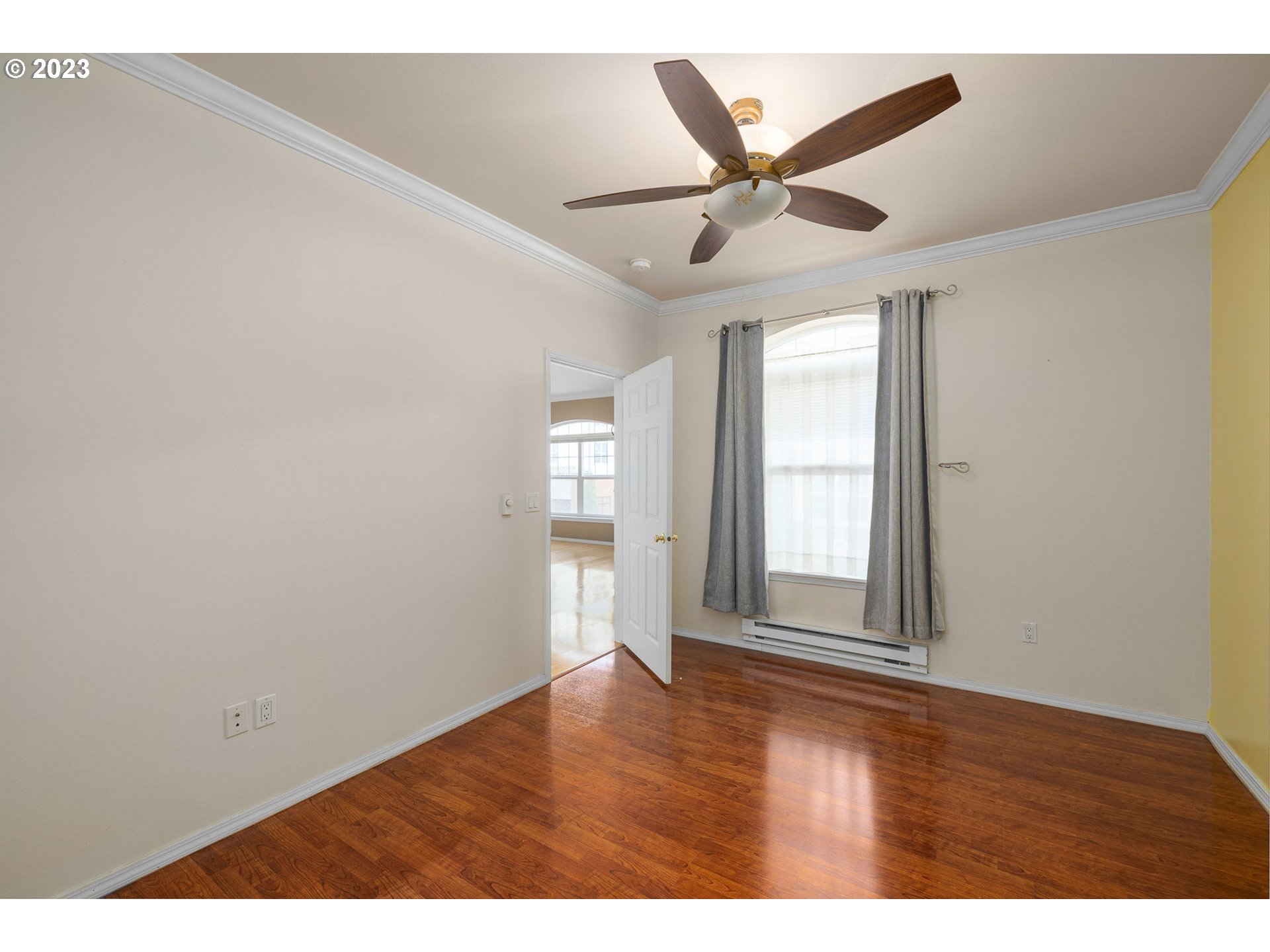 1110 Northeast 63rd Way, Unit 2009 Hillsboro, OR 97124 - Photo 17 of 31 an empty room with wooden floor fan and windows
