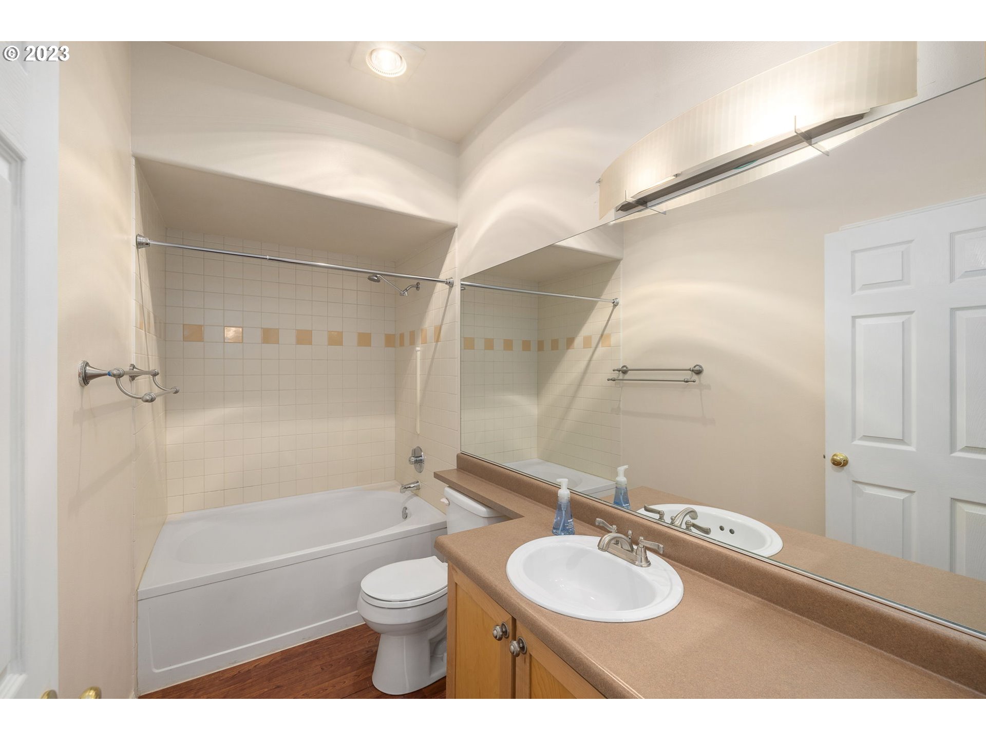 1110 Northeast 63rd Way, Unit 2009 Hillsboro, OR 97124 - Photo 18 of 31 a bathroom with a granite countertop sink toilet a mirror and shower