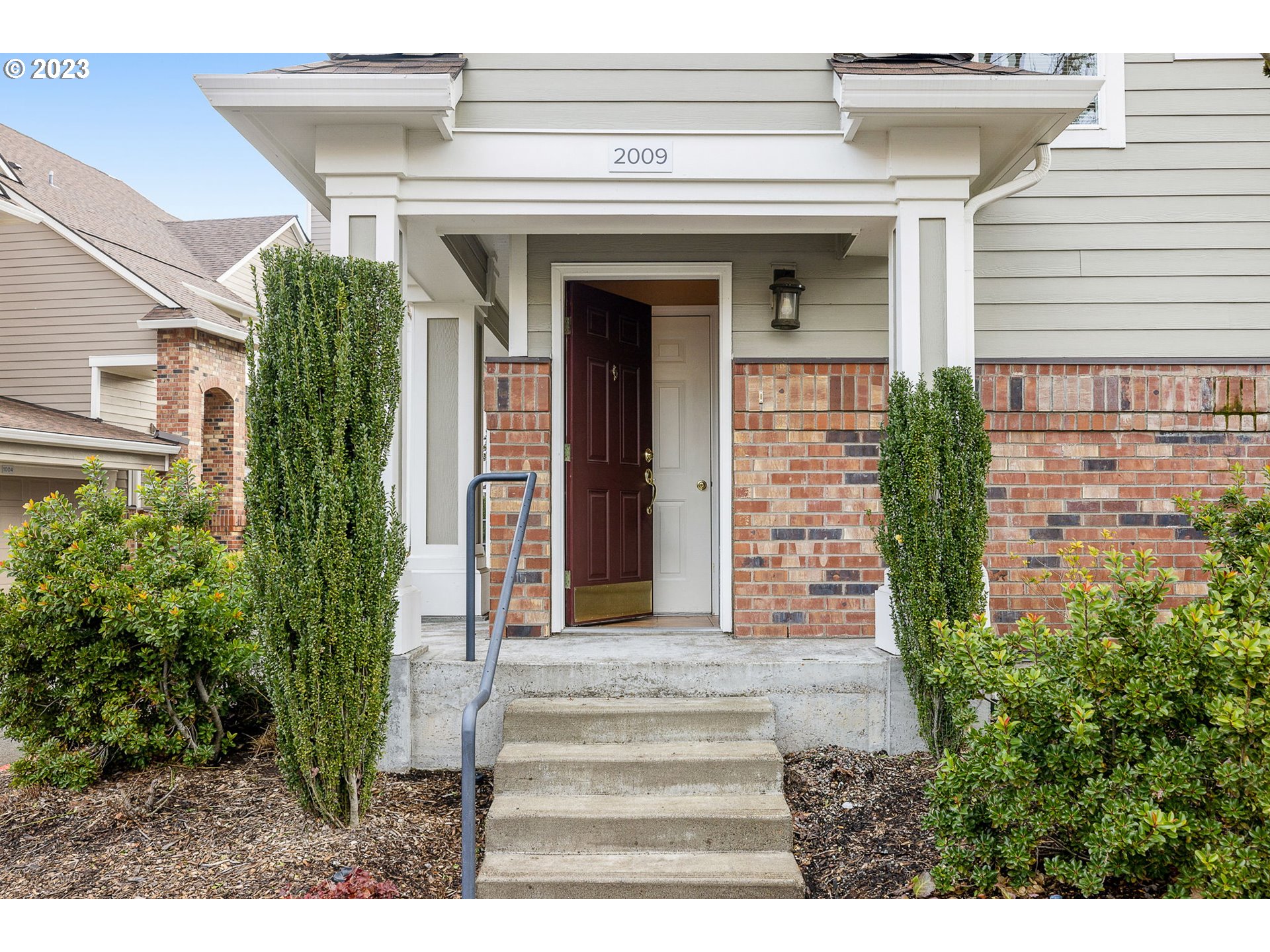 1110 Northeast 63rd Way, Unit 2009 Hillsboro, OR 97124 - Photo 3 of 31 a front view of a house with potted plants