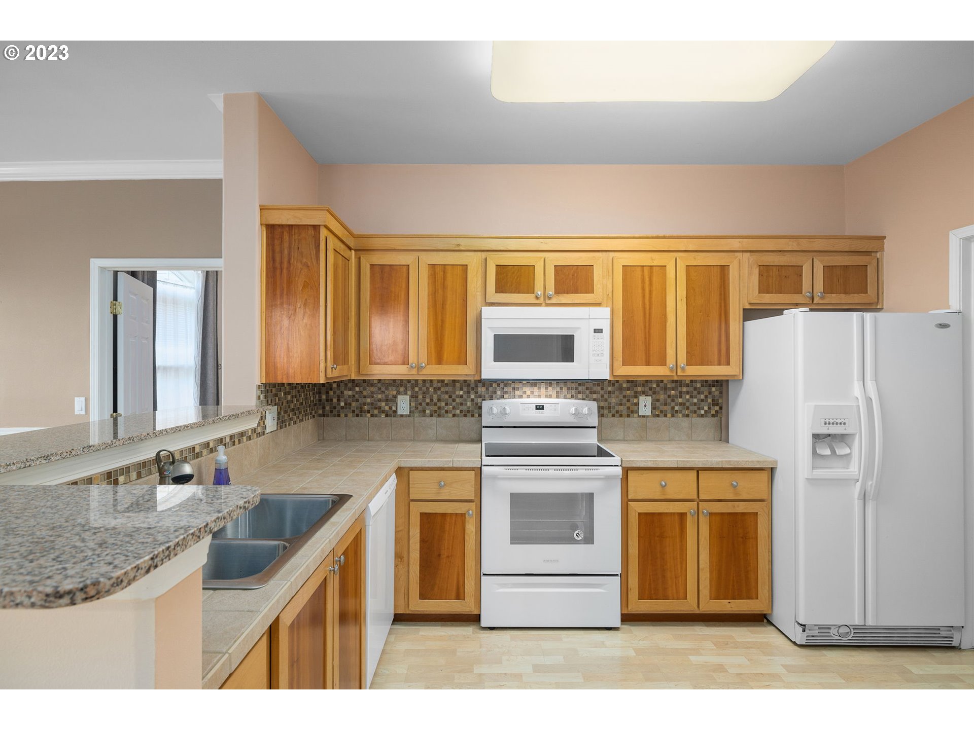 1110 Northeast 63rd Way, Unit 2009 Hillsboro, OR 97124 - Photo 10 of 31 a kitchen with stainless steel appliances granite countertop a sink stove and refrigerator