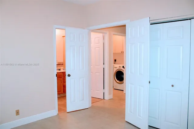 a bathroom with a granite countertop sink and a bathtub