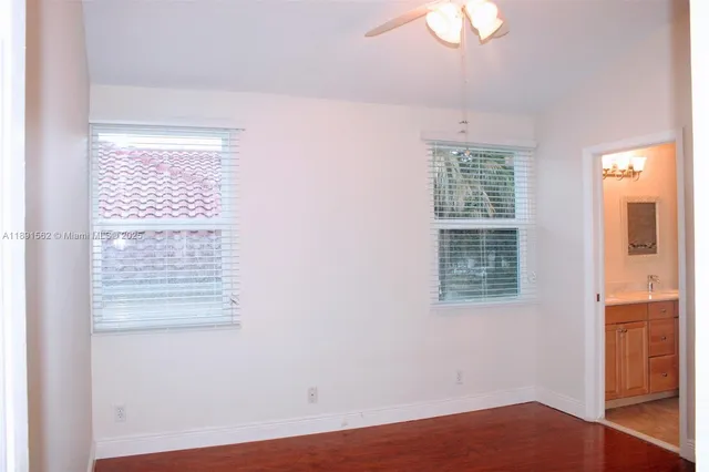 a view of a lake with a floor to ceiling window next to a yard