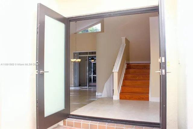 a view of a livingroom with a ceiling fan and window