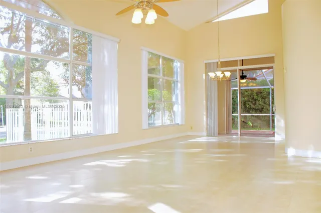 a view of a livingroom with a ceiling fan and a window