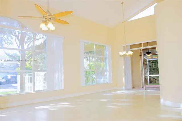 a view of a room with furniture and a flat screen tv
