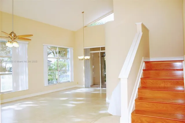 a view of a livingroom with a chandelier furniture and windows