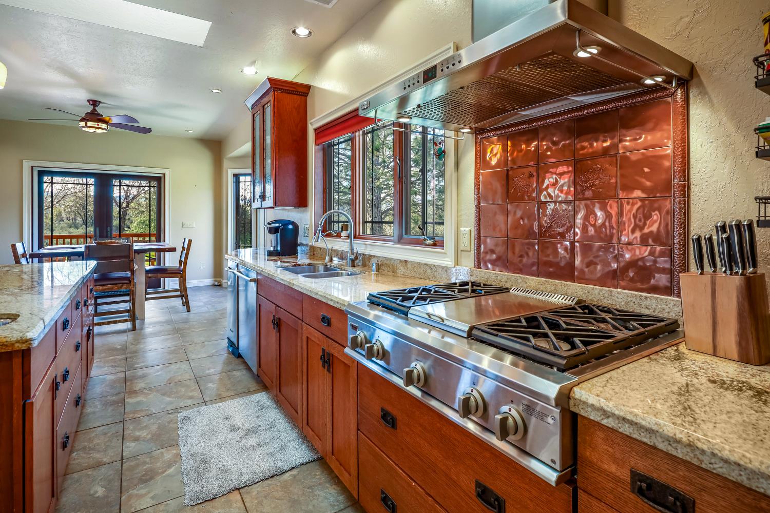 5603 Gold Mountain Road Mountain Ranch, CA 95246 - Photo 18 of 78 a kitchen with stainless steel appliances granite countertop a stove a sink dishwasher and cabinets with wooden floor