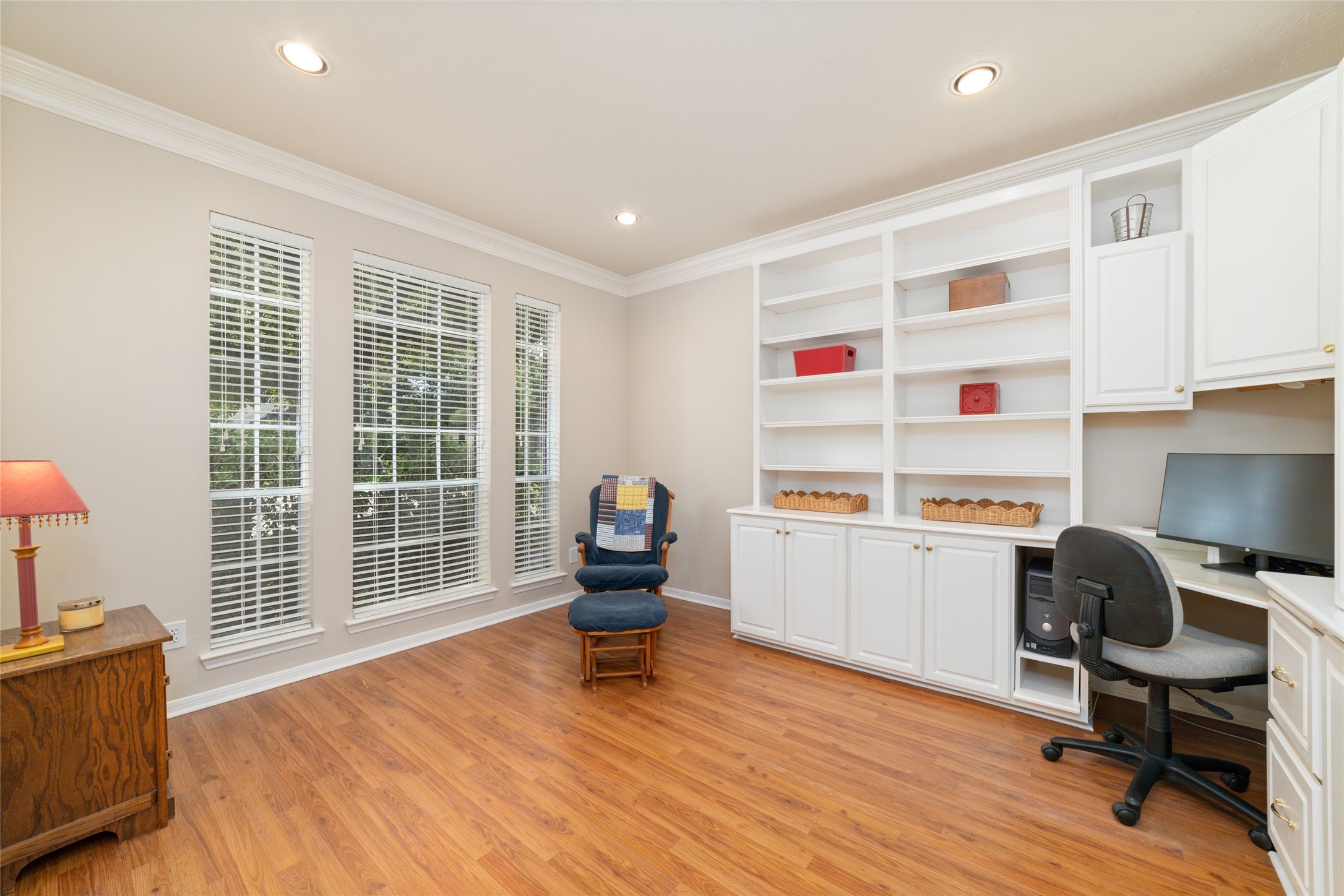 20423 Forest Drive Spring, TX 77388 - Photo 11 of 44 Spacious home office featuring elegant glass-panel French doors for added privacy. Situated at the front of the home, this light-filled room includes beautiful custom built-in shelving and offers serene, scenic views of the front yard.