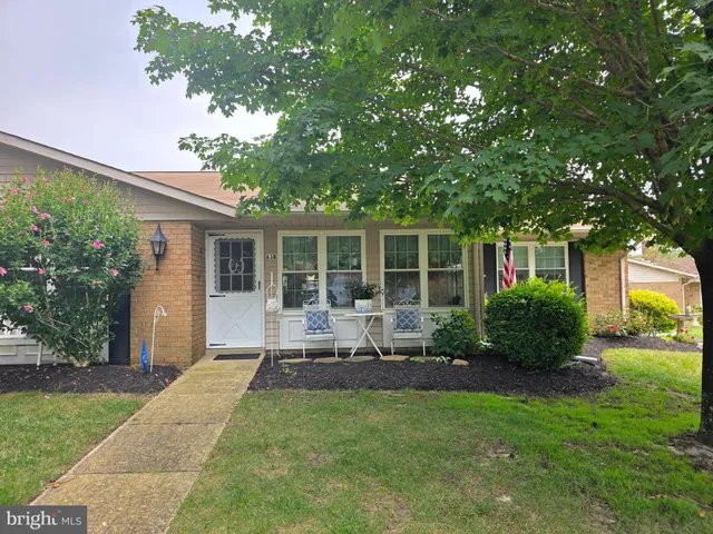 a front view of a house with a yard table and chairs