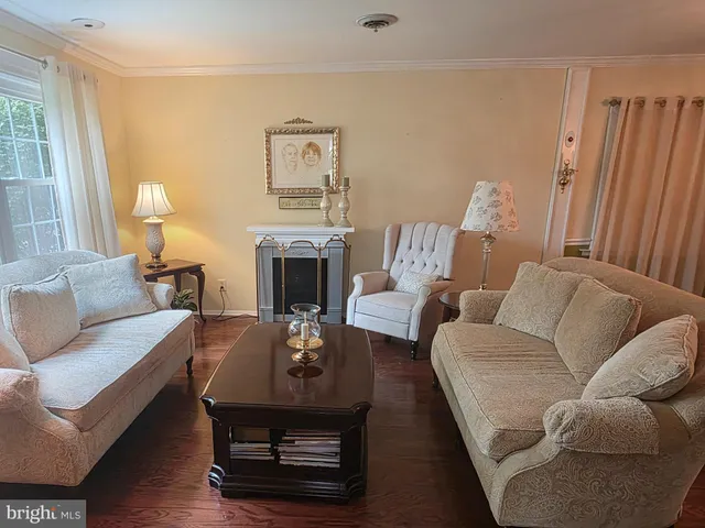 a view of a dining room with furniture a chandelier and wooden floor