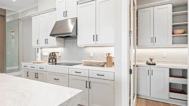 a kitchen with stainless steel appliances a sink stove and cabinets