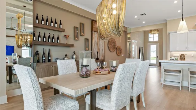 a view of a dining room with furniture and chandelier