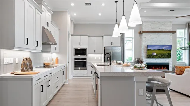 a kitchen with stainless steel appliances kitchen island granite countertop a sink and cabinets