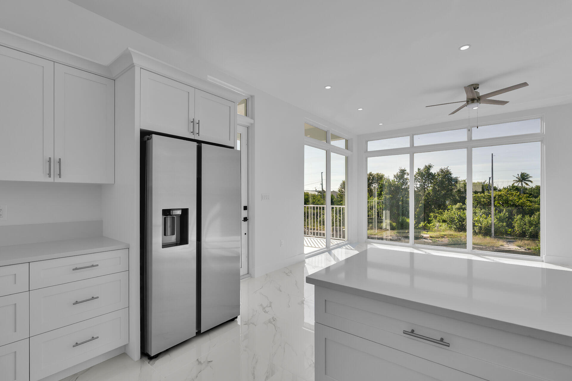 31368 Ave I Big Pine Key, FL 33043 - Photo 11 of 47 a kitchen with windows and refrigerator