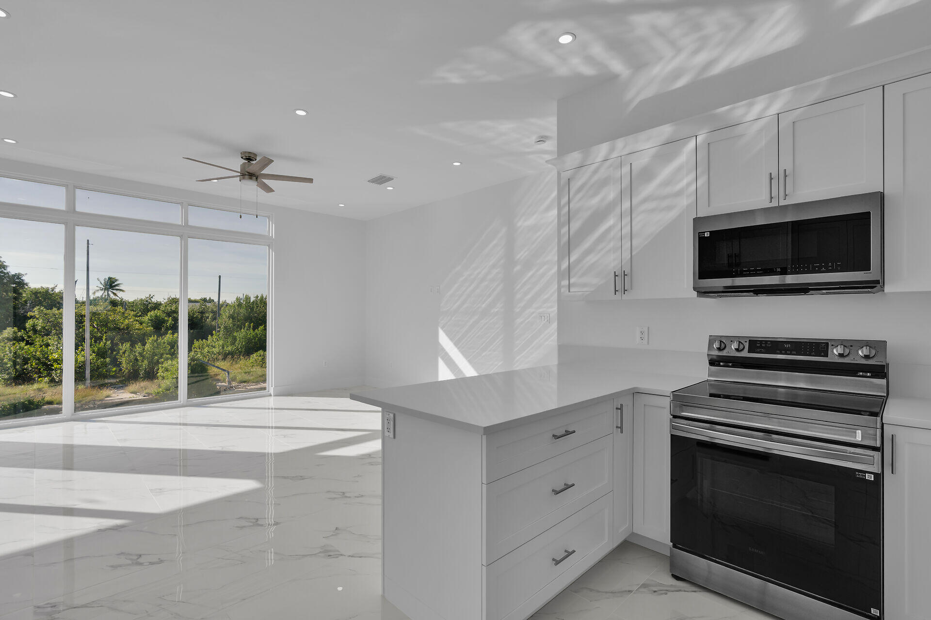 31368 Ave I Big Pine Key, FL 33043 - Photo 12 of 47 a kitchen with a stove and a microwave