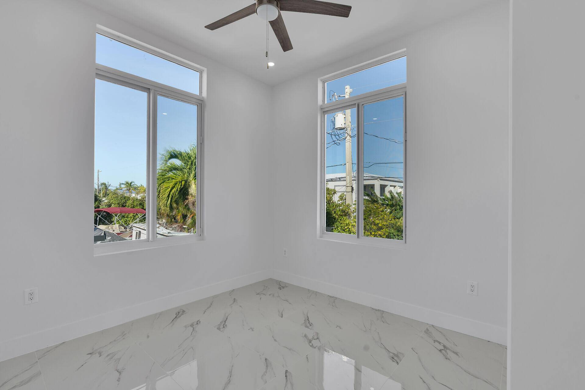 31368 Ave I Big Pine Key, FL 33043 - Photo 22 of 47 an empty room with windows and table
