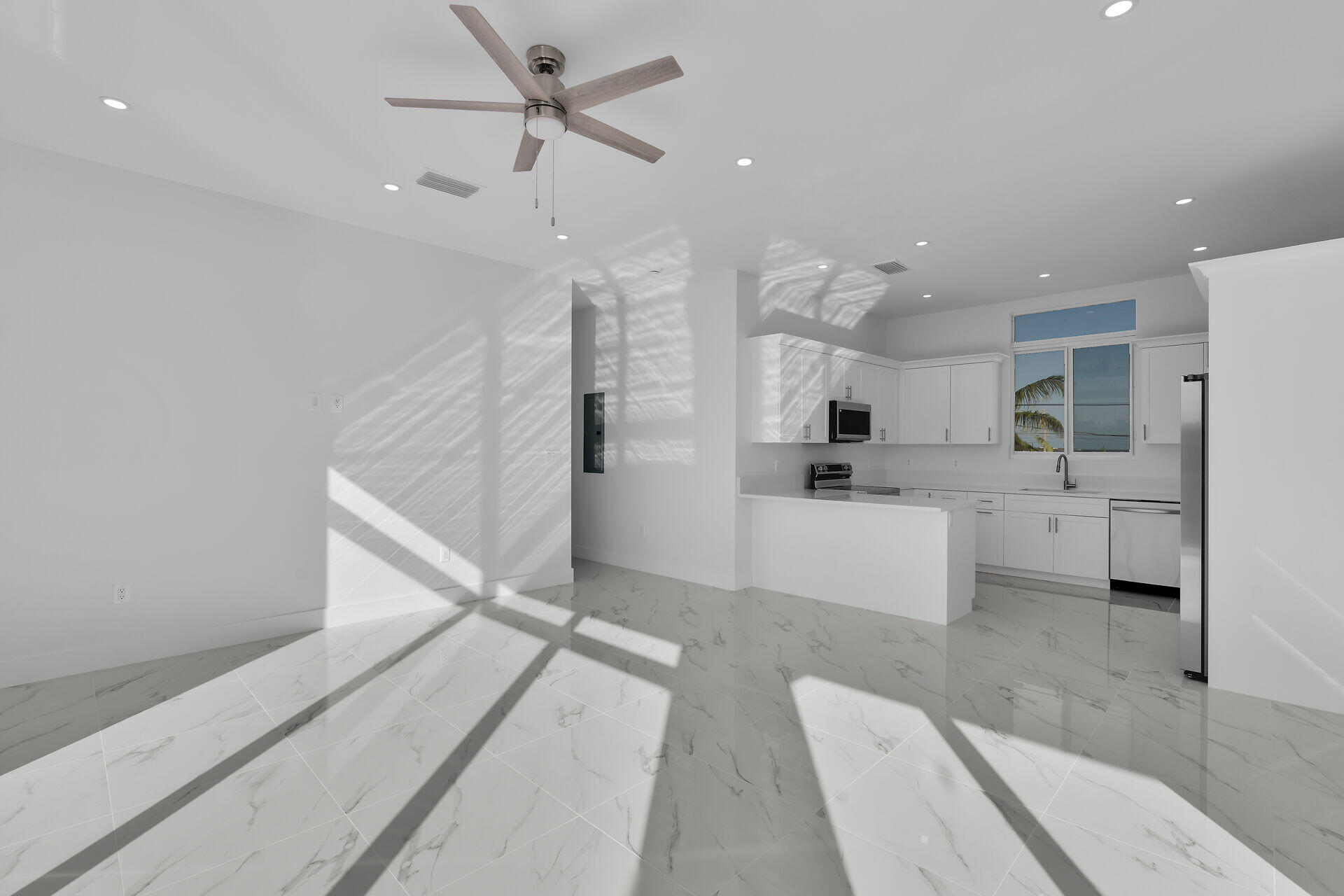 31368 Ave I Big Pine Key, FL 33043 - Photo 9 of 47 a large white kitchen with a white stove top oven and refrigerator