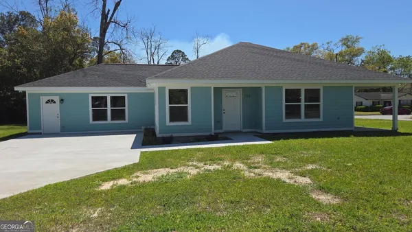 front view of a house with a yard