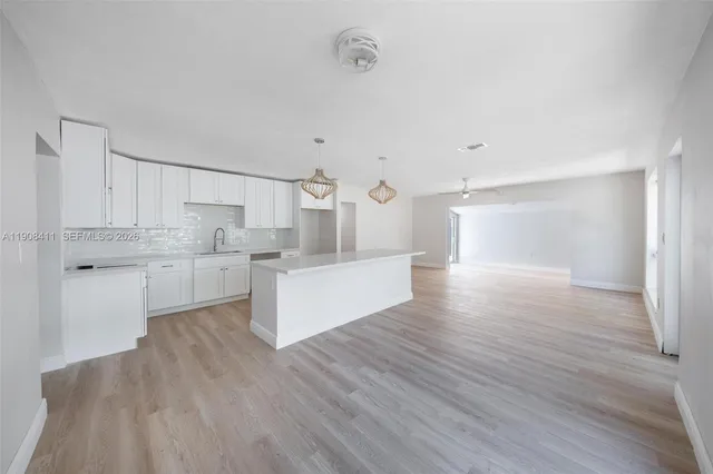 a view of an empty room and wooden floor