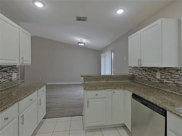a kitchen with a sink and cabinets